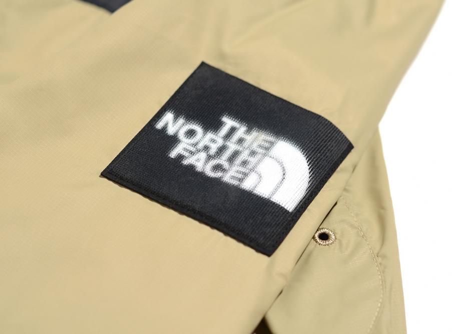 khaki and black north face jacket